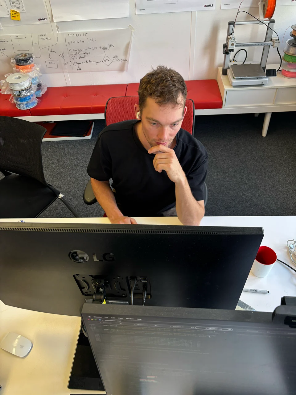 A colleague working behind two monitors