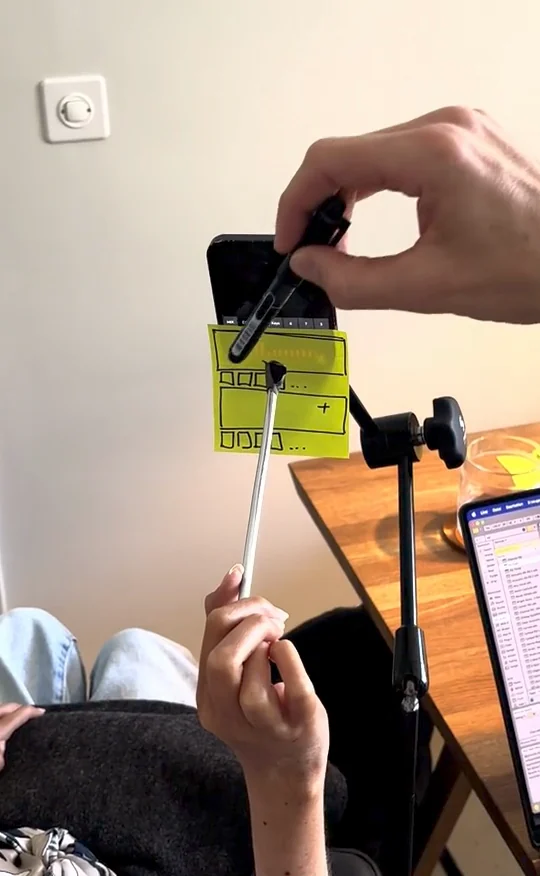 Testing a paper interface with a pointer while a colleague indicates its controls