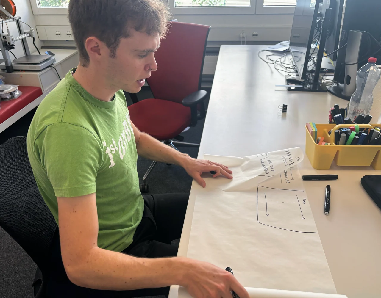 Sketching ideas on paper at the workbench